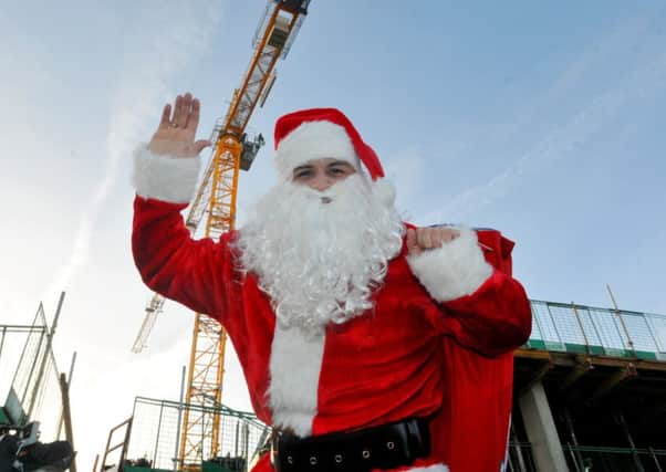 MORECAMBE  18-12-17 Cihan Oktem director and project manager, dressed as Santa, climbs the hugh crane on Stainton Bespoke Homes development, The Broadway, Morecambe, which are due to be finished January 2019.