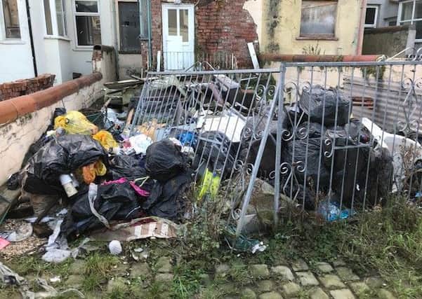 The back yard of a house on Westminster Road is full of flytipped rubbish despite the council regularly collecting it.