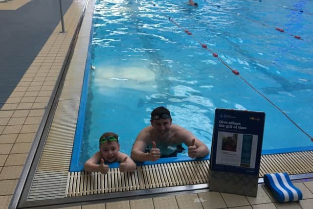 David Lambert with his son Christopher after their sponsored swim.