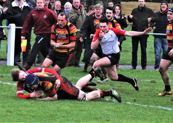 Alex Rogers scores a try for Kirkby Lonsdale.