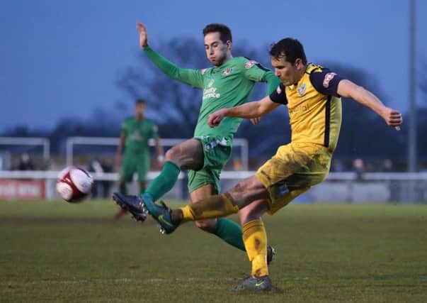Glenn Steel clears under pressure from Nathan Cotterell. Picture: Jonathan White