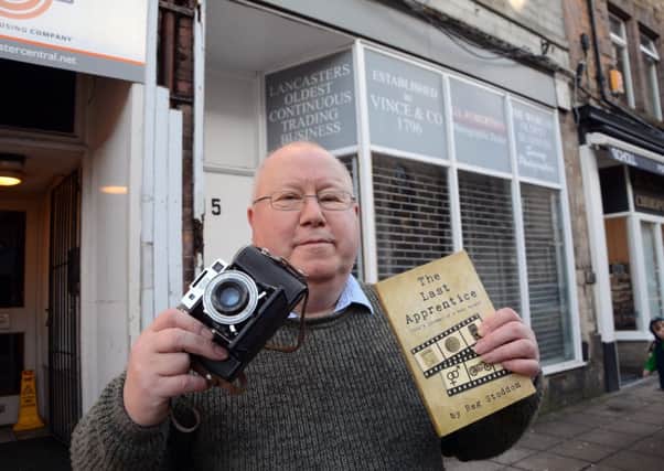 Reg Stoddon with his new book outside the former shop. Photo by Darren Andrews.