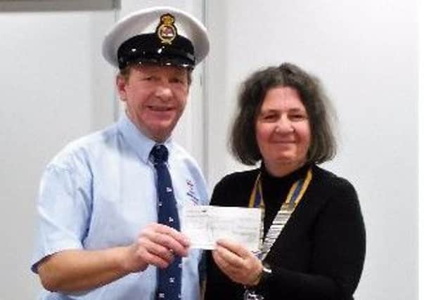 Morecambe RNLI volunteer Colin Midwinter receives a cheque from Rotary Club of Lancaster Loyne President, Susan Wilson