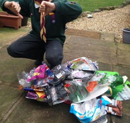 Will Lakin, aged nine, with a few days of household plastic that will end up in landfill...