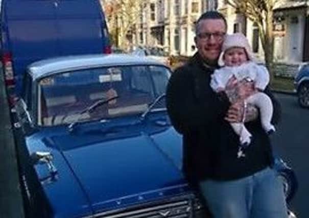 Gaz Fleet, from Morecambe, with his daughter and his restored classic car.