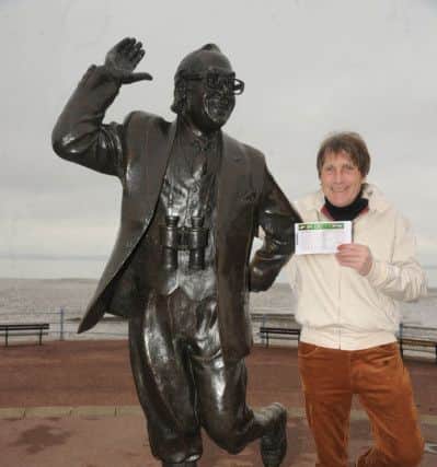 Rennick celebrates on the seafront by the Eric statue.