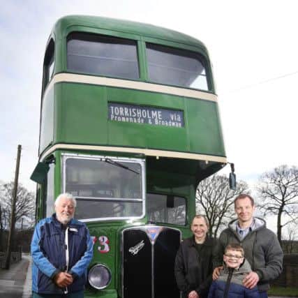 Darren Hunt (extreme right) polishes the 1951 AEC Regent MK III which he and his friend John Hewitt (second right) jointly own and have rebuilt from being in very poor condition. Pictured with them are former owner Ken Wade of Burnley, and Darren's son, Reece, eight.  Picture: Lorne Campbell