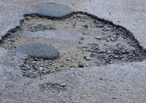 A report to the councils cabinet recommends prioritising repairs to problems such as potholes, broken drain grates, loose paving, and damaged bollards on the busiest roads and pavements.
