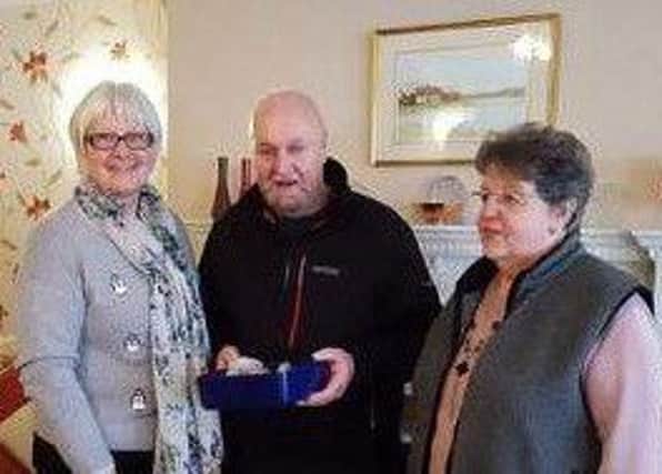 Residents of Homebreeze House present a cheque to Harry Roberts MBE.