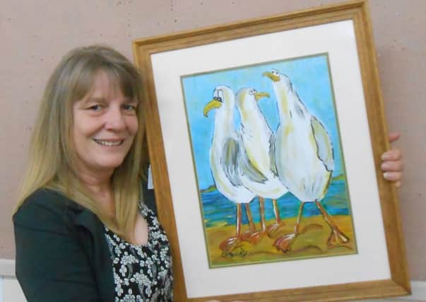 Cathy Daniels with one or her paintings currently on show at Garstang Arts Centre.