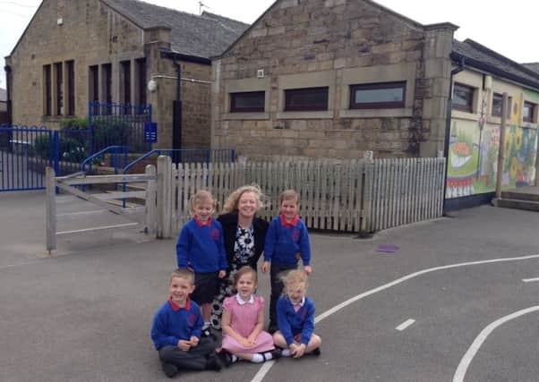St Peter's headteacher Nicola Gomersall with the school's five youngest children in front of the building that will have the work carried out.