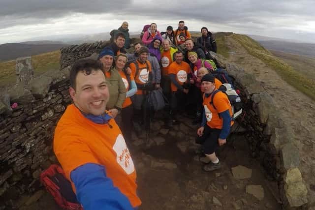 The friends and colleagues of Charlotte and Lee Kirkham at the top of Whernside during their Yorkshire Three Peaks challenge.