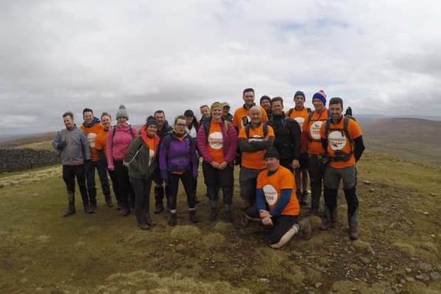 The friends and colleagues of Charlotte and Lee Kirkham at the top of Pen-y-Ghent during their Yorkshire Three Peaks challenge.