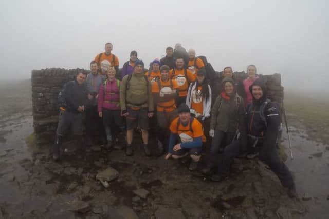 The friends and colleagues of Charlotte and Lee Kirkham at the top of Ingleborough during their Yorkshire Three Peaks challenge.