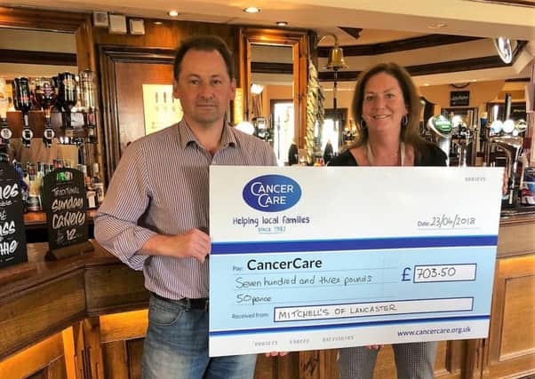Jonathan Barker presents the cheque to Helen Hartin from CancerCare