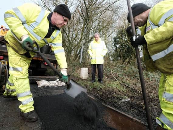County Coun Keith Iddon observes a pothole repair in Chipping