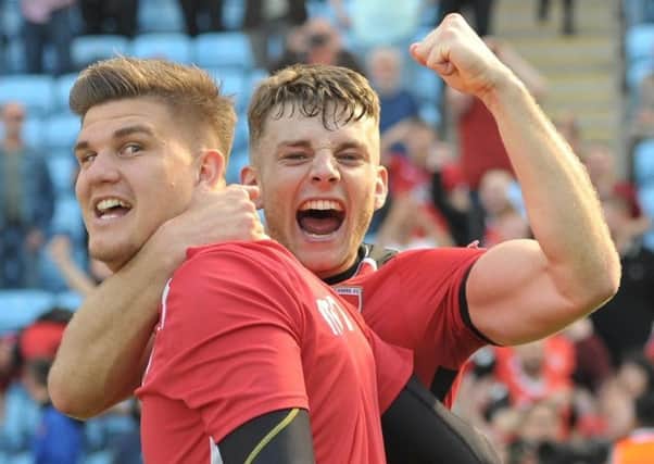 Dan Nizic and Sam Lavelle celebrate Morecambe's point that kept them in League Two     Picture: B&O PRESS PHOTO