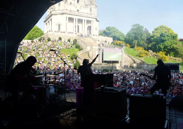 The crowd and the Ashton Memorial from backstage during Cast's performance at Highest Point