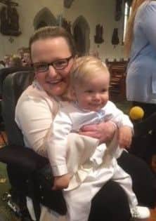 Sarah Melville with her nephew James at his christening.